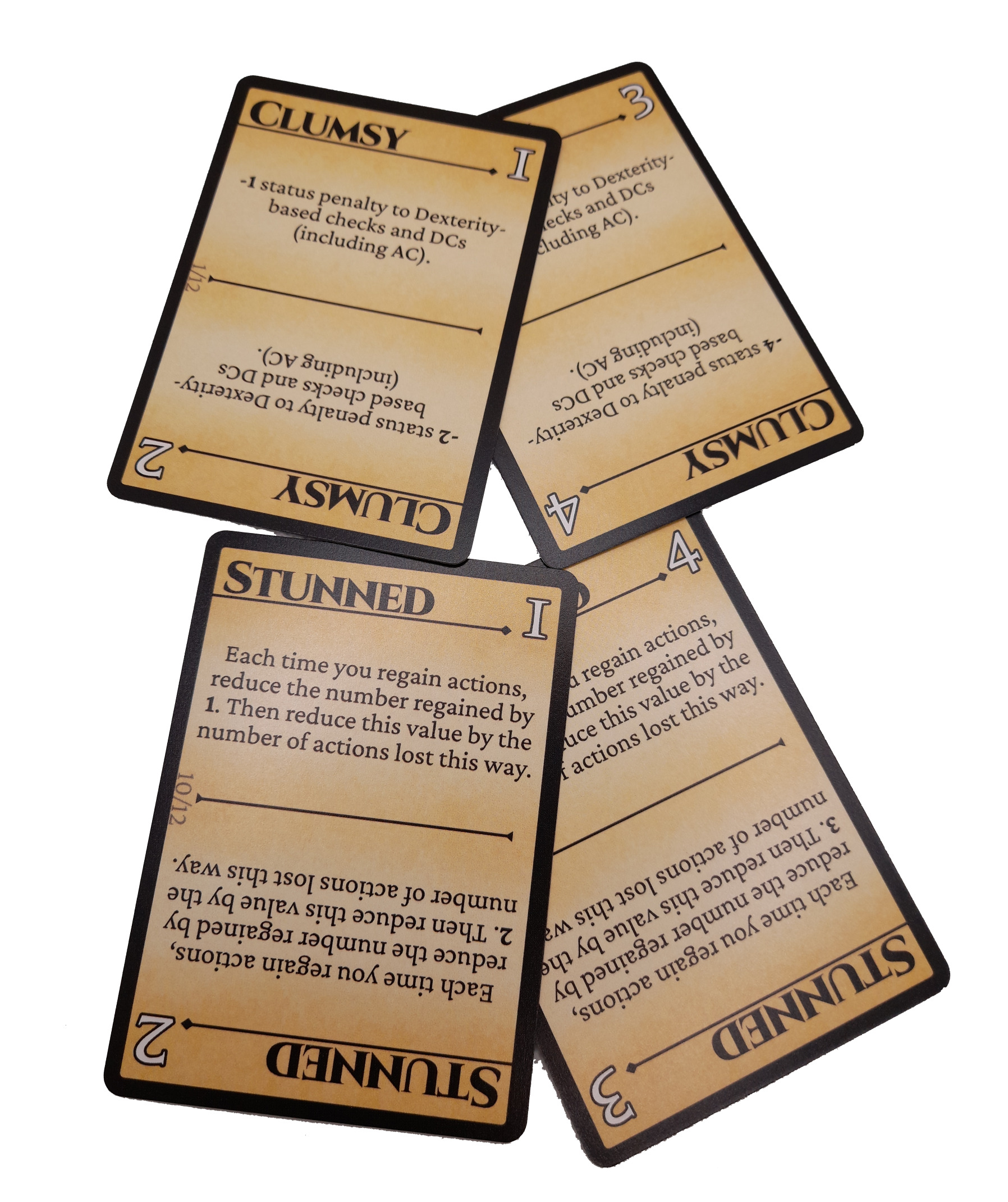 CONDITIONS! cards stack on top of each other. Each card has a bold title and black outline and can be rotated to have different numbers on the top right corner. The cards are labeled: Clumsy and Stunned